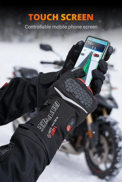 Motorcycle rider using heated touchscreen gloves to operate phone in snowy outdoor setting